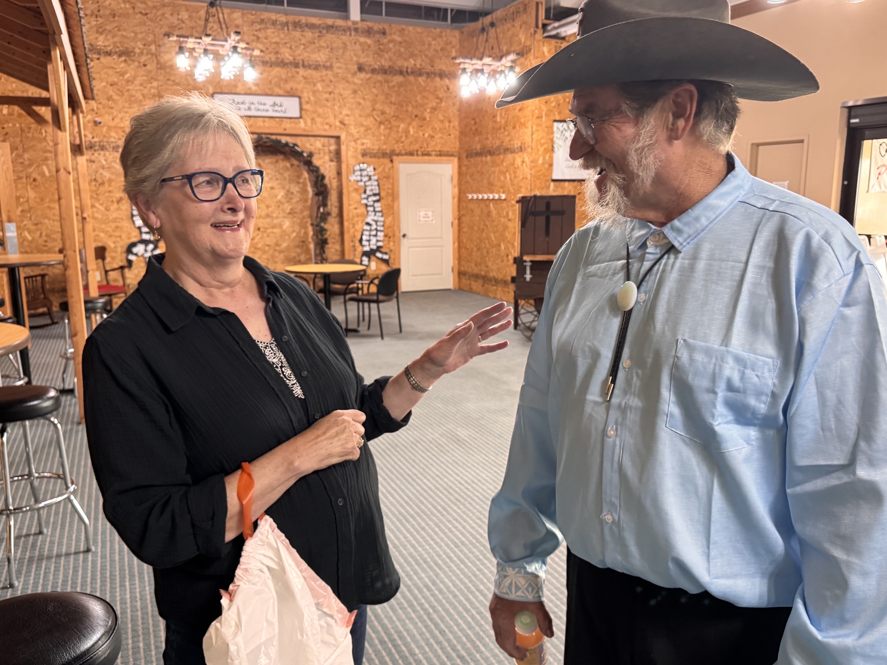 Nancy and Mike welcoming people in the Cowboy Church lobby